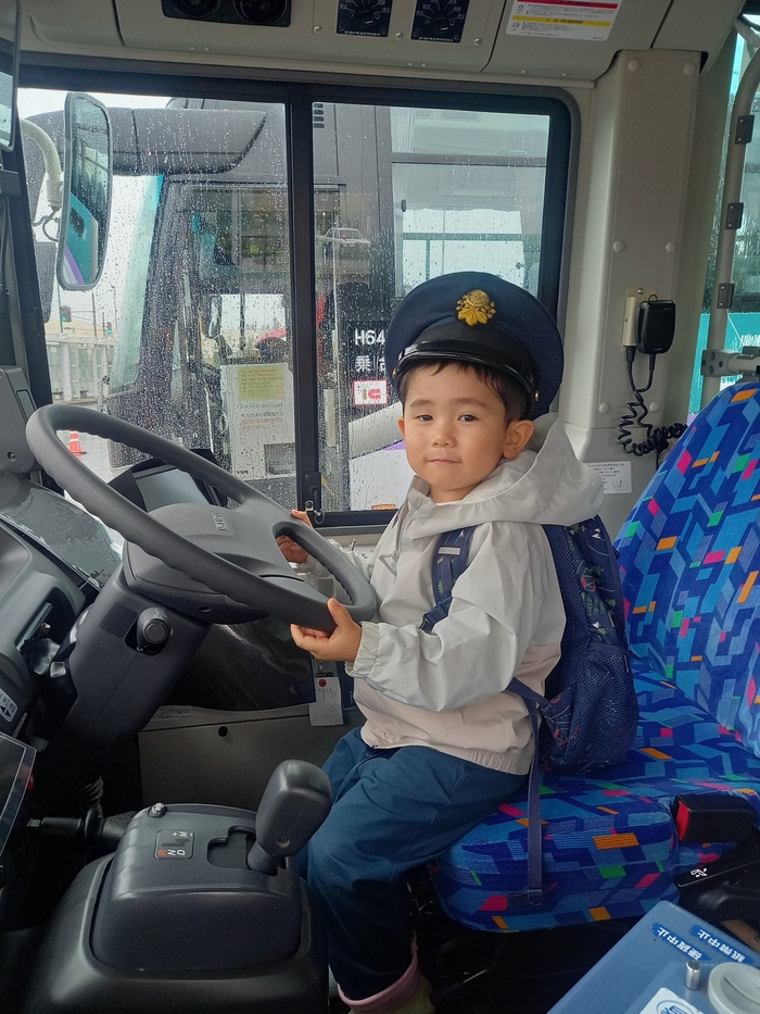 運転席乗車体験をする子どもの写真